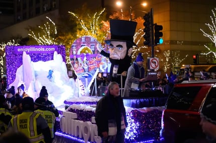 Enjoy Illinois Float Big Lincoln (1)  lights festival on The Magnificent Mile in Chicago, illuminating Michigan Avenue with dazzling displays, festive decorations, and crowds enjoying the lively atmosphere