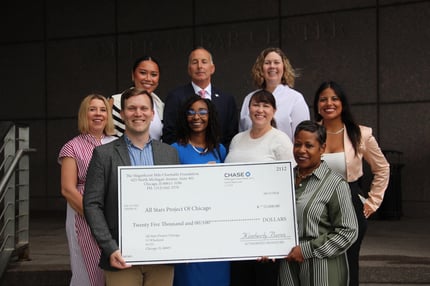 View of The Magnificent Mile, Chicago's renowned shopping district along Michigan Avenue, featuring a variety of stores, dining options, and iconic landmarks. Charitable Foundation Check Presentation