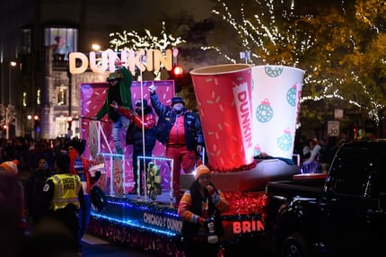 Sugar Hill Gang Dunkin Float (1)  lights festival on The Magnificent Mile in Chicago, illuminating Michigan Avenue with dazzling displays, festive decorations, and crowds enjoying the lively atmosphere